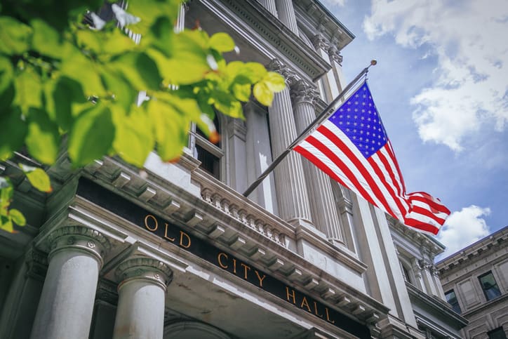 Flag of United States flying over the entrance of Old City Hall in Boston, USA