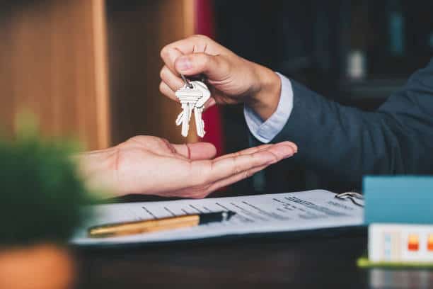 estate agent giving house keys to woman 