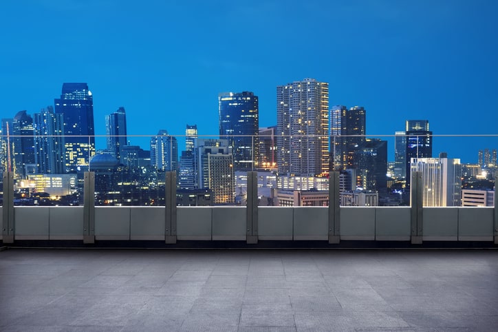 Empty terrace with cityscape and skyscraper at night